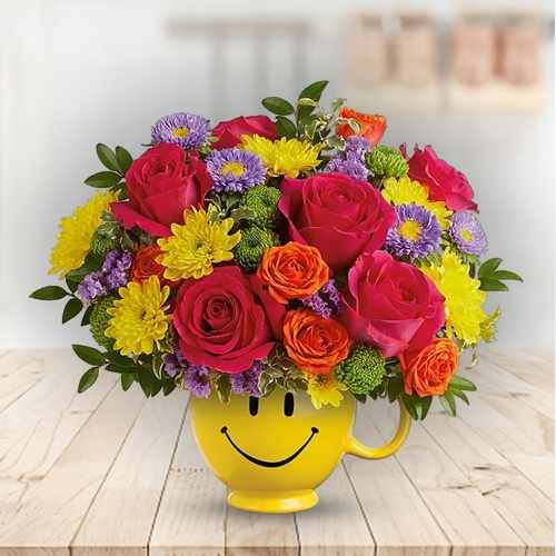 Happy Blooms – Cheerful Floral Arrangement In A Smiley Mug Vase USA | Petals Of Joy Arrangement